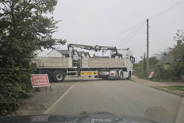 A lorry and trailer on a narrow road in Eye