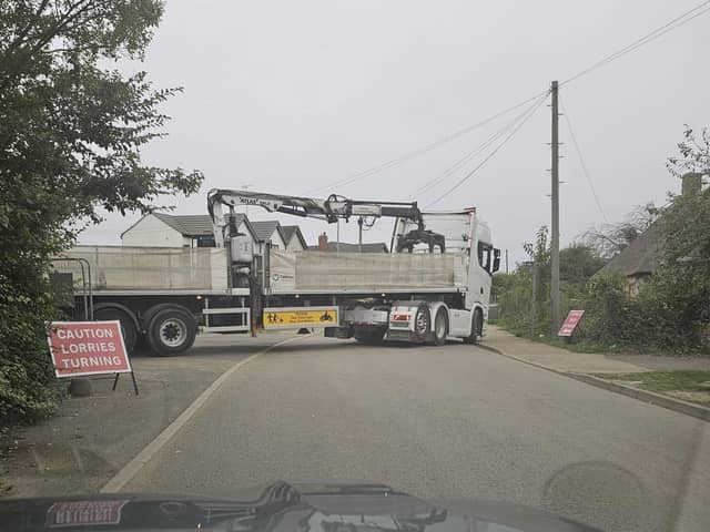 A lorry and trailer on a narrow road in Eye