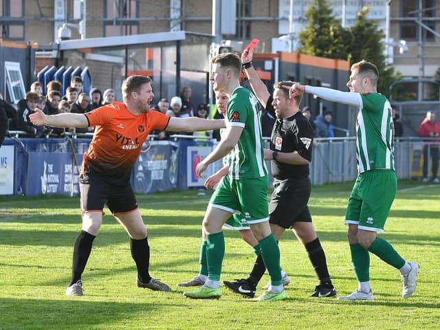 Peterborough Sports joint manager Michael Gash (orange) is not happy as the referee brandishes a red card in the direction of Ryan Fryatt. Photo David Lowndes.