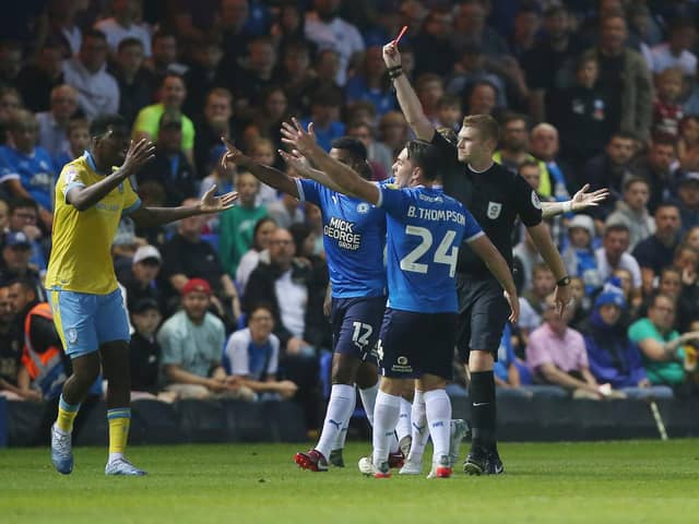Reece James of Sheffield Wednesday is shown a red card by referee James Oldham in the game against Posh. Photo: Joe Dent/theposh.com.