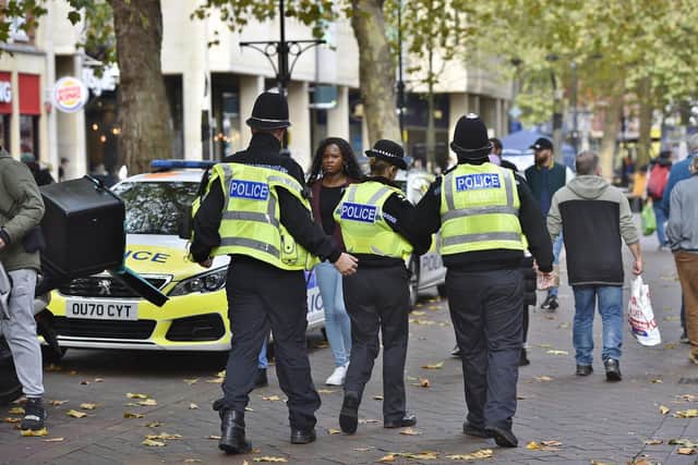 Police and football fans in the city centre before the Cambridge game