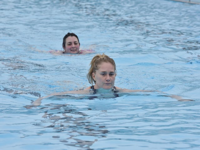 Swimmers attending the first session of the Lido season.