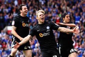 Craig Mackail-Smith celebrates a goal for Posh in the League One play-off final at Old Trafford in 2011. With him are Lee Tomlin (left) and George Boyd (right). Photo by Dean Mouhtaropoulos/Getty Images.
