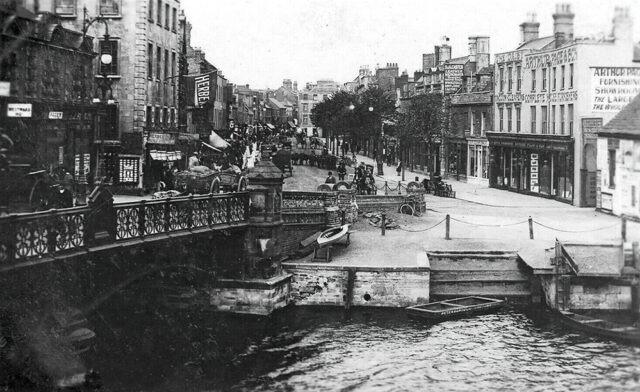 A lovely view along a busy Broad Bridge Street as captured from the old Town Bridge in the early 1900s. In the foreground is the old wharf that is now buried under the current Town Bridge, and in the distance is a herd of cattle being moved away from the city centre and, presumably, the cattle market (image: Peterborough Images Archive)