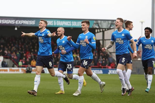 Jack Taylor leads the celebrations after shooting Posh in front against Morecambe. Photo: Joe Dent/theposh.com.