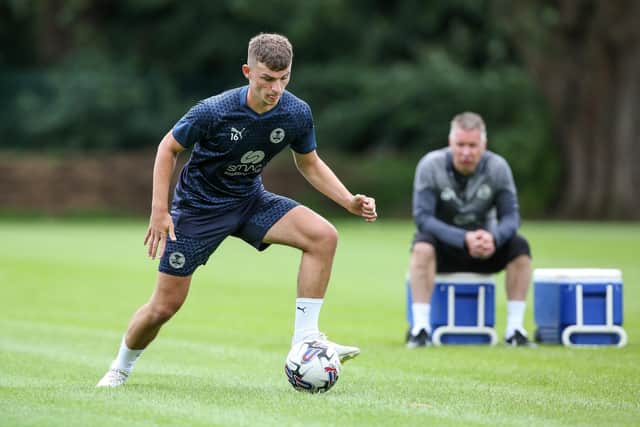 Harrison Burrows during pre-season training watched by Darren Ferguson. Photo: Joe Dent/theposh.com