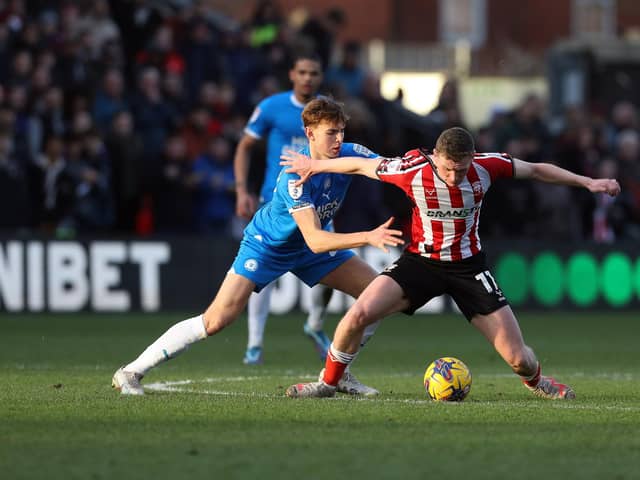 Hector Kyprianou of Peterborough United battles with Ethan Hamilton of Lincoln City. Photo: Joe Dent/theposh.com.
