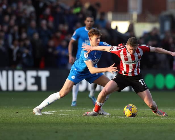 Hector Kyprianou of Peterborough United battles with Ethan Hamilton of Lincoln City. Photo: Joe Dent/theposh.com.