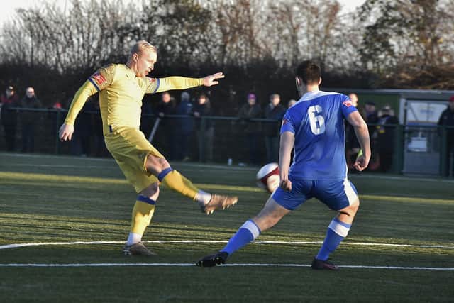 Lewis Hilliard (yellow) shoots at goal for Spalding v Yaxley. Photo: David Lowndes.