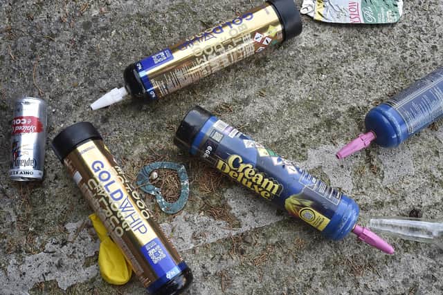 Rubbish and nitrus oxide cannisters left discarded in the car park.