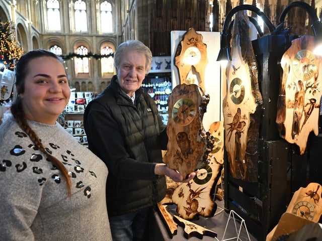 Naomi Price with clock-maker Bob Foster at Peterborough Cathedral Christmas market.