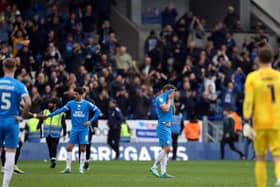 Peterborough United players look dejected at full-time in front of the Portsmouth fans. Photo: Joe Dent.