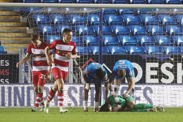 Nicholas Bilokapic of Peterborough United is congratulated by team-mates after making a save against Doncaster Rovers. Photo: Joe Dent.