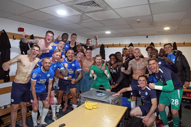 Peterborough United players celebrate securing a play-off place in the changing room at Barnsley at full-time. Photo: Joe Dent/theposh.com.