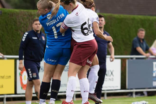Katie Middleton of Posh Women in an aerial duel during the National League game with Northampton. Photo: Ruby Red Photography