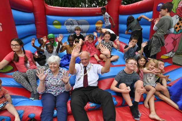 Deputy mayor of Peterborough Nick Sandford and Deputy mayoress Bella Saltmarsh with children attending the Family Voice Peterborough summer barbecue, in Orton Goldhay