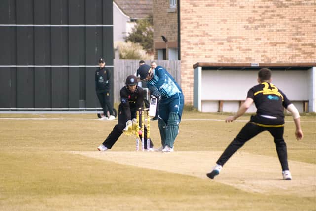 Mark Saunders of Ramsey CC bowls Histon's Will Brown. Photo: Sean Hill