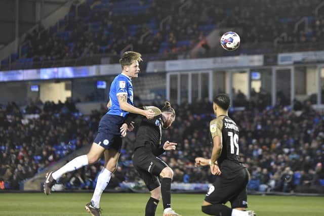 Posh centre-back Frankie Kent wins a header against Portsmouth. Photo: David Lowndes.