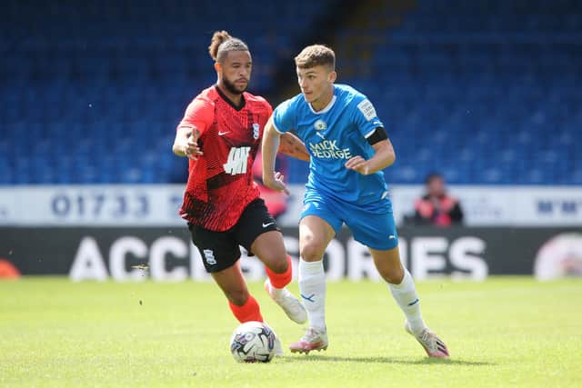 Harrison Burrows of Peterborough United gets away from Tyler Roberts of Birmingham City. Photo: Joe Dent/theposh.com
