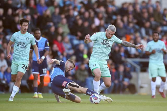 Jack Marriott of Peterborough United in action with Lewis Wing of Wycombe Wanderers. Photo: Joe Dent/theposh.com.