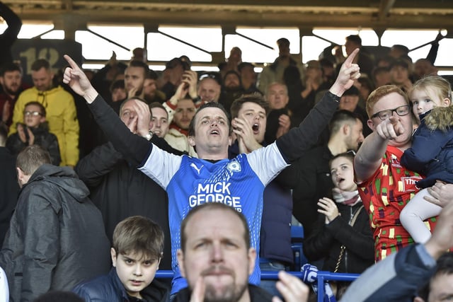 Peterborough United fans are pictured watching the crucial win over Derby County.
