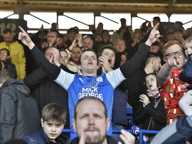 Peterborough United fans are pictured watching the crucial win over Derby County.