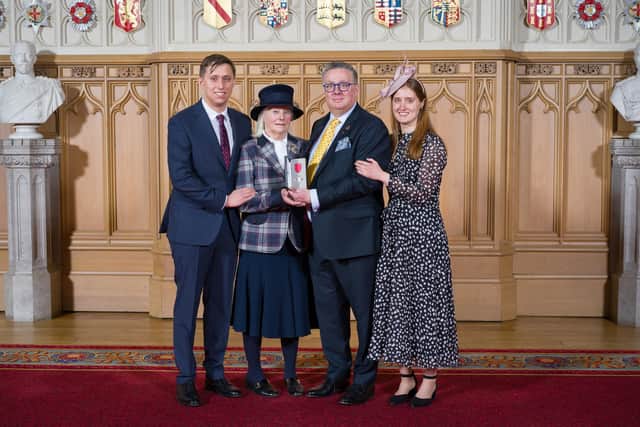"Bursting with pride" - MIchael Sly collecting his MBE at Windsor Castle with mum Pam, and children William and Lucy