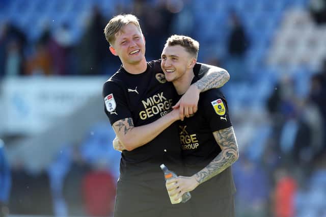 Frankie Kent and Jack Taylor of Peterborough United celebrate the victory at Shrewsbury. Photo: Joe Dent/theposh.com