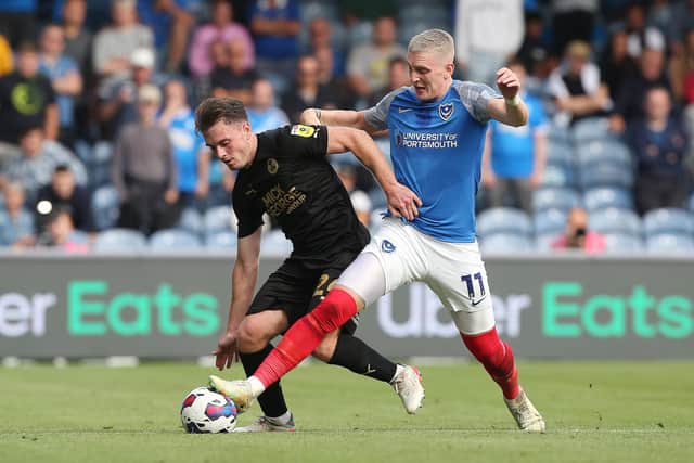 Ben Thompson of Posh battles with Ronan Curtis of Portsmouth. Photo: Joe Dent/theposh.com