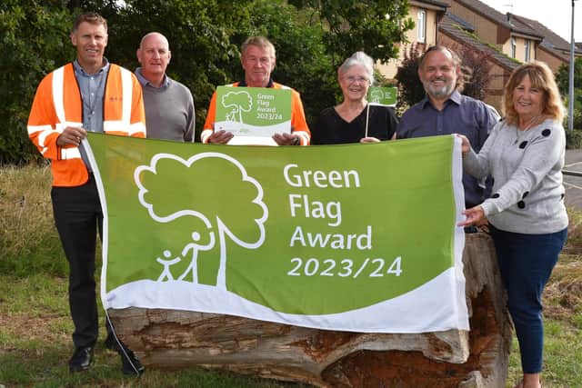 Aragon staff and members of the Eye Open Space Group celebrate the Green Flag Award. Photo: Eye Open Space Group