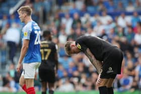 Posh centre-back Frankie Kent cuts a dejected figure at full-time at Portsmouth. Photo: Joe Dent/theposh.com.