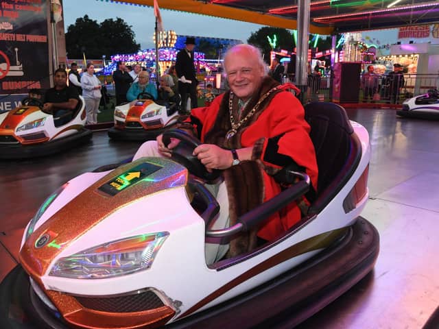 Mayor of Peterborough Nick Sandford opens the Bridge Fair at the Embankment . Taking the wheel of one of the dodgems.