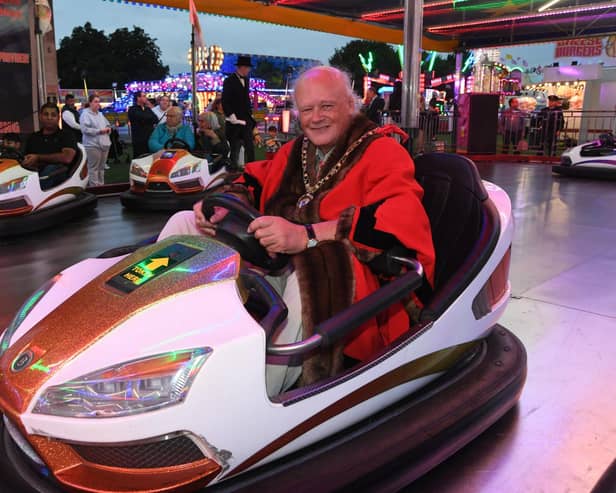 Mayor of Peterborough Nick Sandford opens the Bridge Fair at the Embankment . Taking the wheel of one of the dodgems.