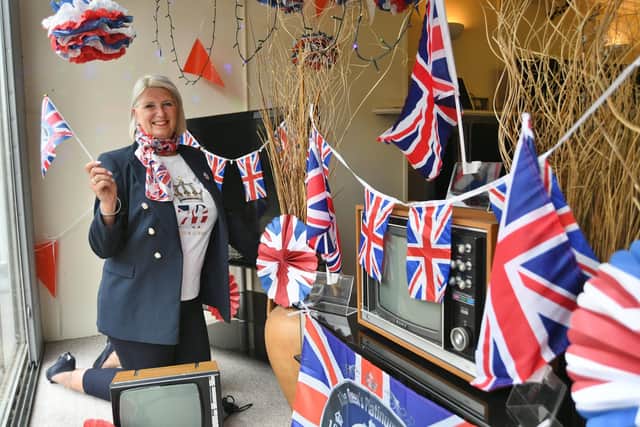 Hayley Cotton-Shelton with her window display for Her Majesty The Queen's Platinum Jubilee