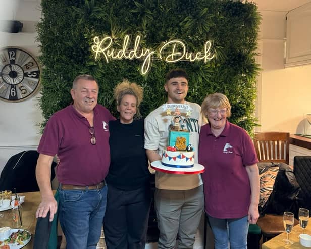 Nigel Cook Ruddy Duck Landlord, left,  Jo the chef and Annette, the barmaid present Matty with a special cake to celebrate his victory.