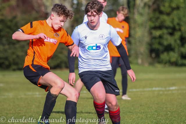 Nene Valley Under 16s skipper Spencer Wales (orange) in action against Werrington. Photo: Charlotte Edwards.