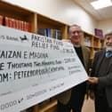 Tim Alban-Jones, vice dean of Peterborough Cathedral, presents a cheque for £1,200 to Abdul Choudhuri, chairman of the Faizan-e-Madina Mosque, for the Pakistan Floods Appeal