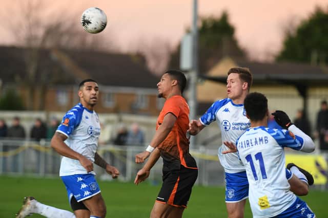 Kaine Felix (orange) in action for Peterborough Sports against Tamworth. Photo: David Lowndes.