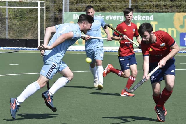 Ben Newman (red) in action for City of Peterborough against Old Georgians. Photo: David Lowndes.