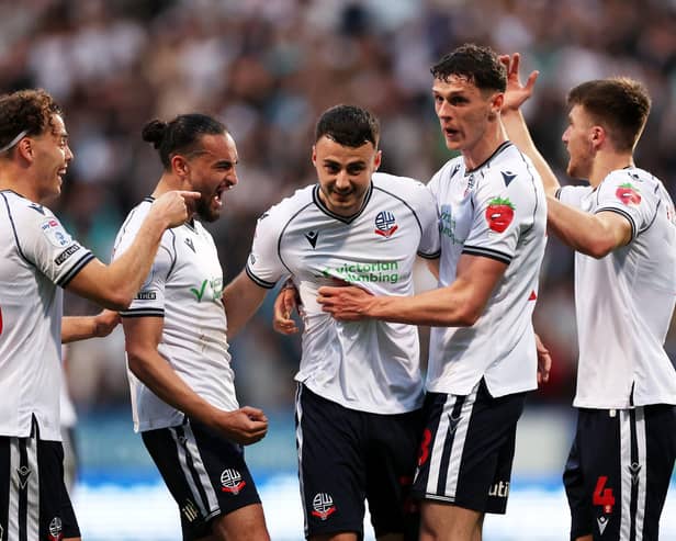 Bolton players celebrate an Aaron Collins goal against Barnsley. Photo by Michael Steele/Getty Images.
