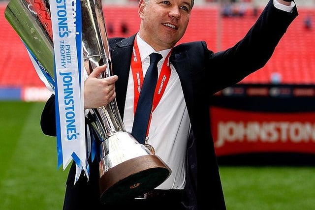 Manager Darren Ferguson celebrates with the trophy.
