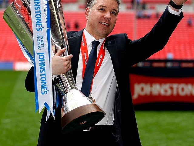 Manager Darren Ferguson celebrates with the trophy.