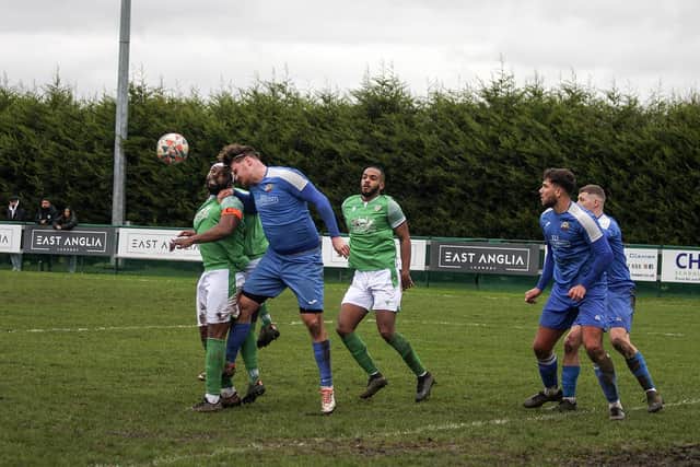 Romeo Ugbene (green, left) in action for FC Peterborough against Cornard. Photo Tim Symonds
