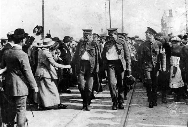 The walking wounded arrive in Goldsmith Avenue, Fratton, in October 1914. Bugler Clark of the Dorset Regiment (right) carries a German helmet as a trophy