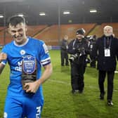 Posh skipper Harrison Burrows with his man of the match award after the 3-0 win over Blackpool. Photo: Joe Dent/theposh.com