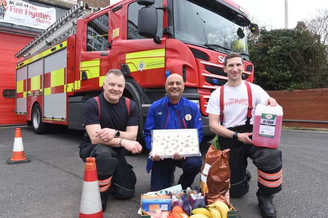 Stanground Fire Station green watch fire fighters at their annual Fire Fighters Charity car wash. Pictured are Matt Gosney, crew commander, Matt House, watch commander and Ejaz Moghul, a Tesco community champion who supplied goods for the event