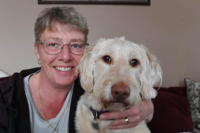 Rachel Wood with her labradoodle Riley - who needs surgery to replace his hips - at home in Paston.