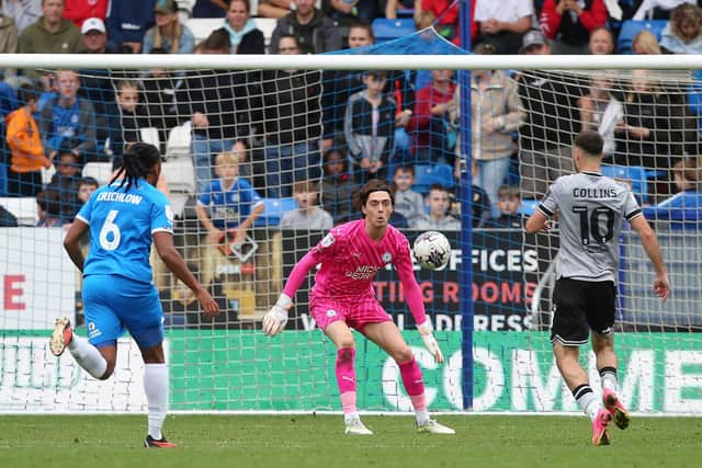 Nicholas Bilokapic of Peterborough United keeps his eye on the ball as Aaron Collins of Bristol Rovers steams through on goal. Photo: Joe Dent/theposh.com.