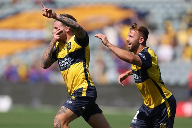 Jason Cummings (left) celebrates a goal for Central Coast Mariners. Photo by Scott Gardiner/Getty Images.