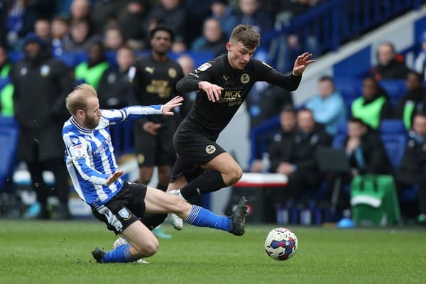 Harrison Burrows of Peterborough United is tackled by Barry Bannan of Sheffield Wednesday. Photo: Joe Dent/theposh.com.